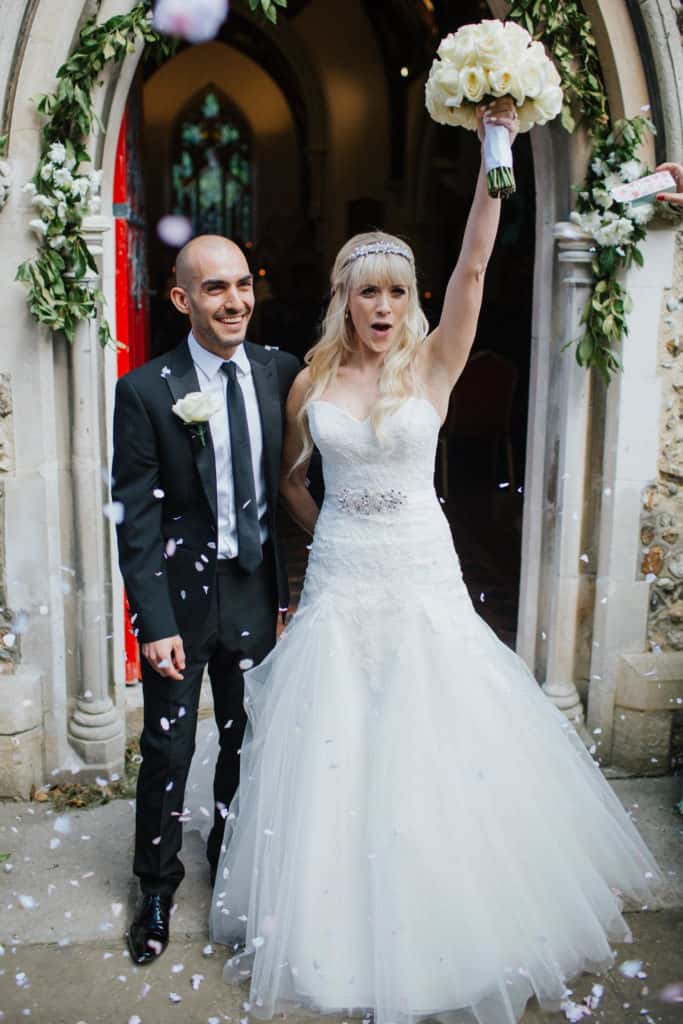 Bride punching the air after her wedding ceremony