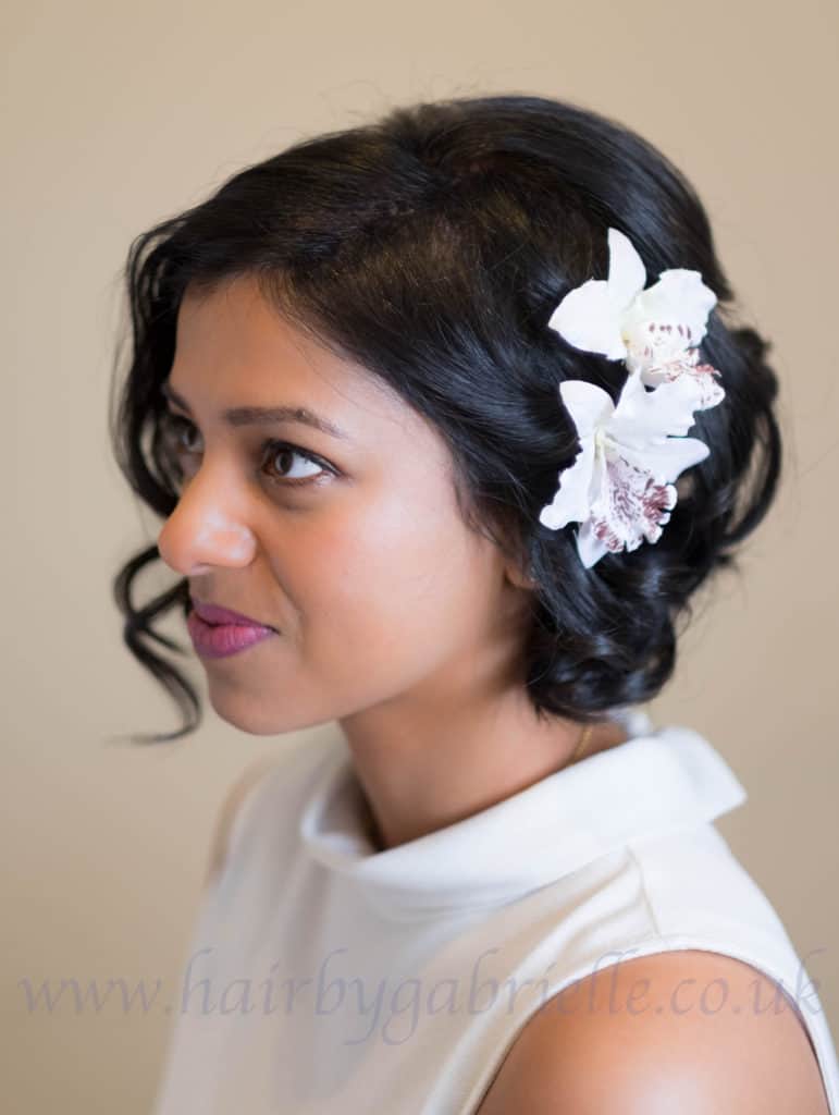 Bride seen in profile with orchids in her hair